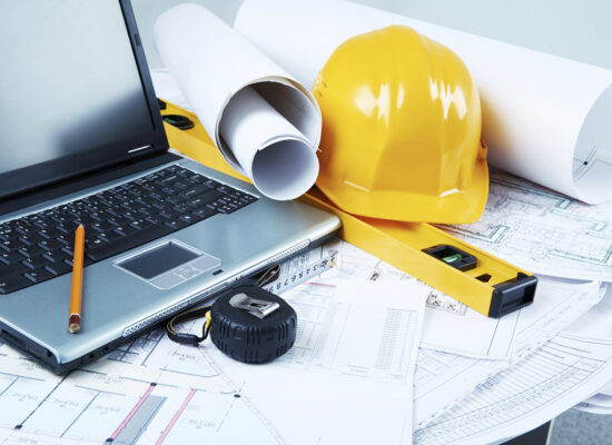 Image of laptop, architectural tools and blueprints